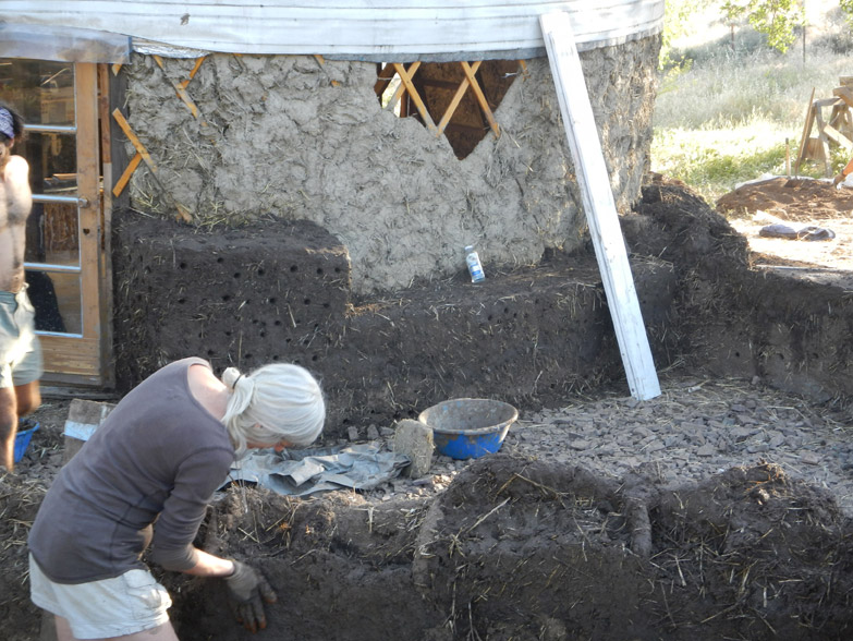 We levelled the wall to create the base for shelf arches. See where the bottle is? That's where the shelves will be erected.