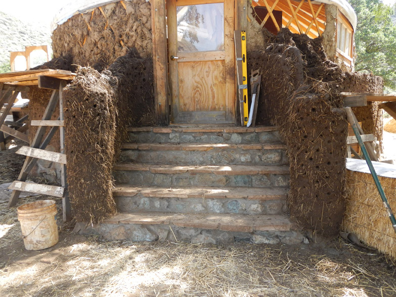 Cob columns around the entry way. Eventually the columns and the walls got built as high as the roof to create an enclosed space around the stairs.