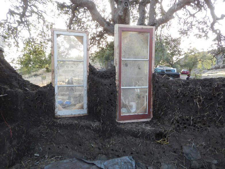 These 2 windows are facing west, where the hot afternoon sun comes from. To avoid direct sun from overheating the house, the windows are turned on an angle.