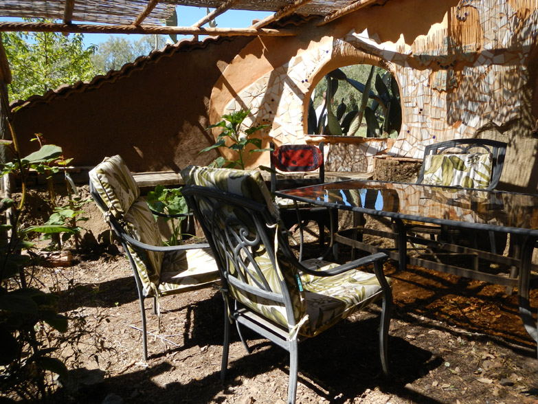 Outdoor courtyard surrounded by cob wall