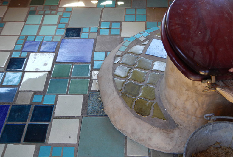 Tiled bathroom with compost toilet outside the "Playhouse"