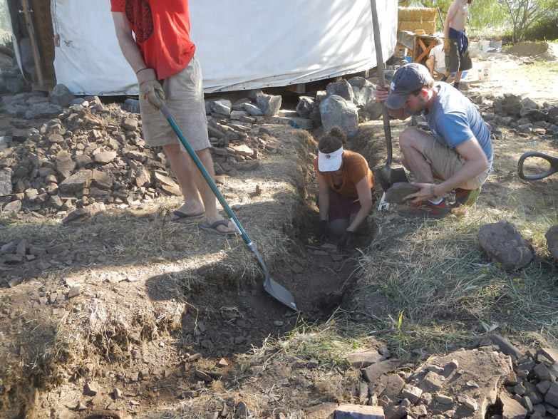 The stony soil dug out of the trench is sifted, and the remaining gravel returned to the trench